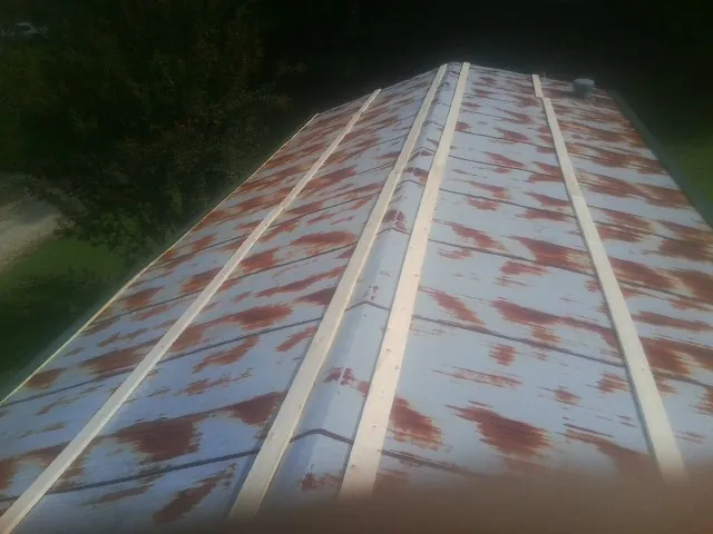 Rusted metal roof panels with new wood purlins before replacement — Storm Damage Roof Repair in Lake Hughes by Roofing Brothers